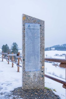 Stone monument with text board on a snowy path in winter, Sinnraum, Oberreute, Allgäu, Bavaria,