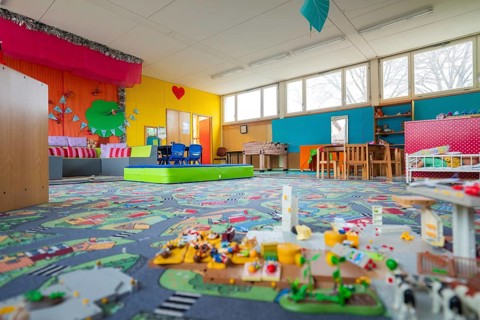 Friendly play area with colorful walls and toys, suitable for lively play, homework supervision,