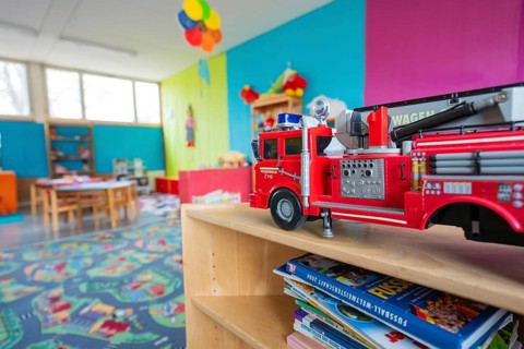 Child-friendly room with toy fire department and colorful walls, suitable for imaginative fun,