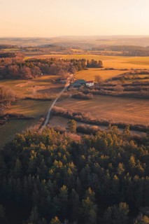 Fields and farm surrounded by forests at dusk, warm colors create a peaceful atmosphere, Gechingen,