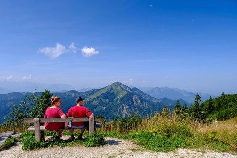 Hikers, mountaineers on a rest bench, in the summit area, at Hochfelln, near Bergen, Chiemgau,