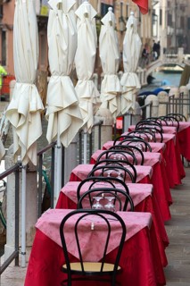 Tables set on the canal of a restaurant, Venice, Veneto, Italy