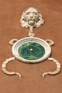 Relief of a lion's head on a house wall, Venice, Veneto, Italy
