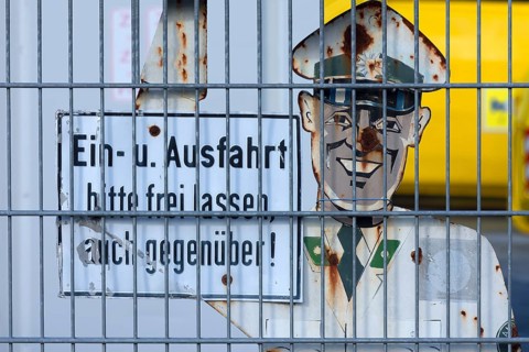 1950s traffic police officer metal sign behind a wire fence, Bavaria, Germany