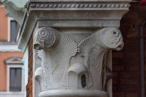 Captain design with fish figures on the arcades of the historic market in Rialto, Venice, Veneto,