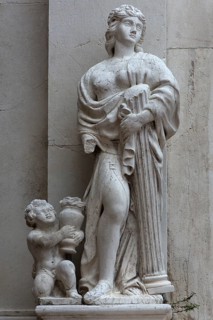 Female sculpture with a column in her arms, Venice, Veneto, Italy