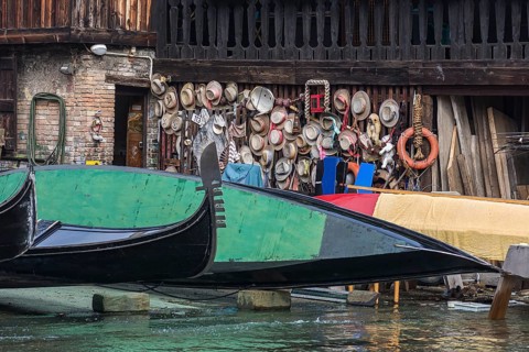 Gondolier straw hats on a wooden wall of a shipyard, Venice, Veneto, Italy