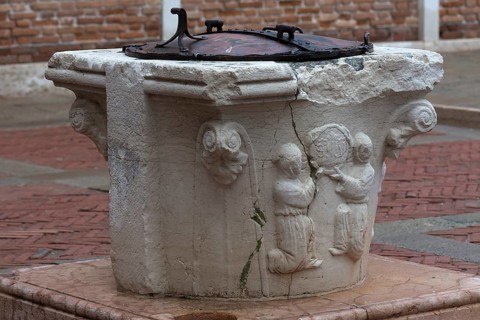 Old fountain with relief design, Venice, Veneto, Italy