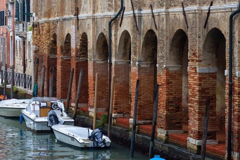 Arcade with brick columns on the canal, Venice, Veneto, Italy