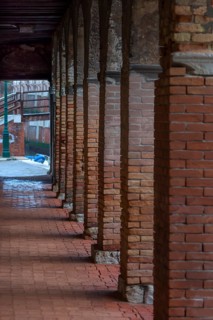Arcades with brick columns in the old town, Venice, Veneto, Italy