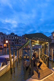 Gondolier waiting for tourists, Venice, Veneto, Italy