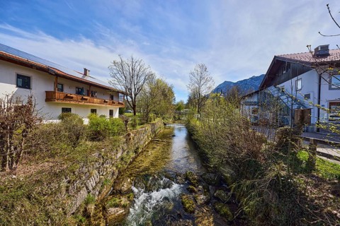 Rote Traun river, fortified bank, riverbed, quarry stone wall, rapids with stones, bushes with