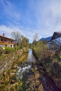 Rote Traun river, fortified bank, riverbed, quarry stone wall, rapids with stones, bushes with