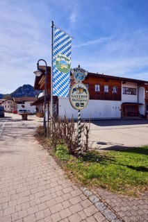 Privatbrauerei Ayinger, advertising flag on flagpole, Hirschbichler inn and butcher shop,
