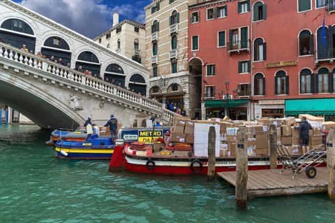 Delivery of parcel mail by ship at the Rialto Bridge, Venice, Veneto, Italy