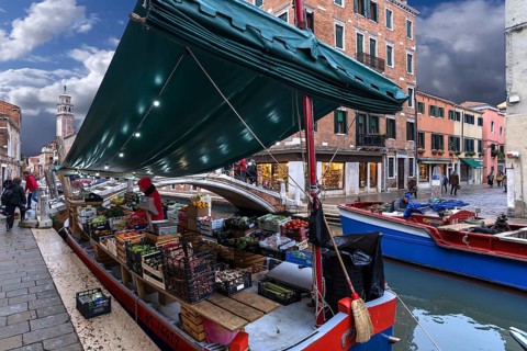Selling fruit and vegetables from a ship, Venice, Veneto, Italy