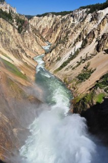 A powerful river rushes through a narrow canyon fringed by dramatic cliffs, Grand Canyon of the