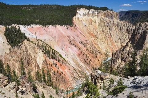 An impressive colorful canyon with rugged rocks crossed by a wooded plain, Grand Canyon of the