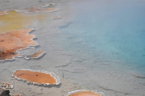 Hot spring with colorful, natural geology consisting of orange and blue, Yellowstone National Park,