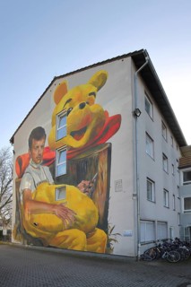 Mural Waldsterben by CASE MaClaim 2024, man with yellow plush toy, bear figure, street art,