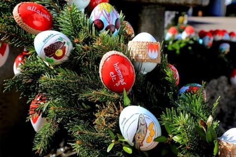 Detail of an Easter fountain in Franconian colors red and white, eggs with inscriptions on