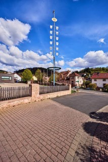 Maypole, sandstone wall, wooden fence, roads, general buildings, residential buildings, hills,