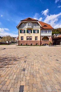 Town hall, commercial building, façade with windows, shutters and façade painting, hipped roof,