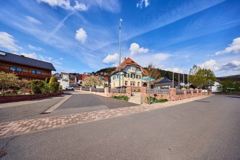 Town hall, maypole, flagpoles, roads, commercial buildings, residential buildings, single-family