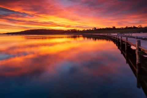 Jetty at sunrise on Geiseltalsee, artificial lake, open-cast mining lake, recultivated open-cast