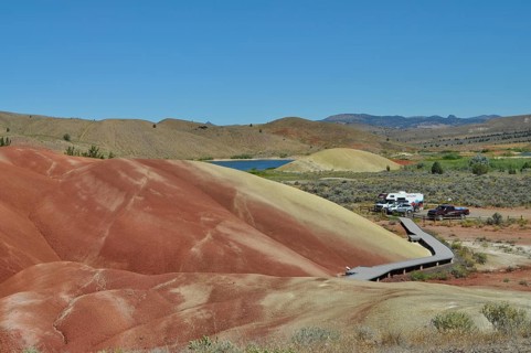 Parking lot and wooden path surrounded by colored hills, John Day Fossil Beds National Monument,