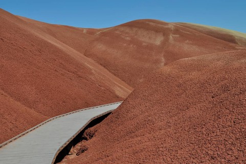 Wooden trail through red, hilly landscape, John Day Fossil Beds National Monument, Painted Hills
