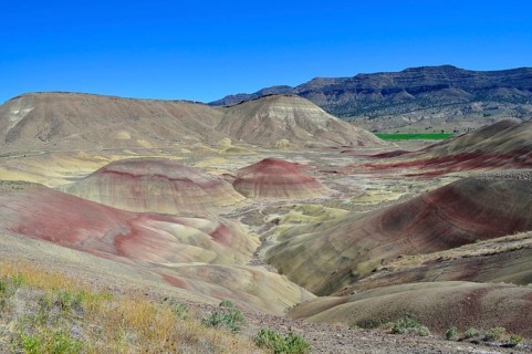 Wide landscape with multicolor hills and blue sky, John Day Fossil Beds National Monument, Painted