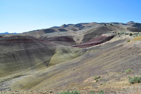 Colorful, eroded hills under clear skies with varied scenery, John Day Fossil Beds National