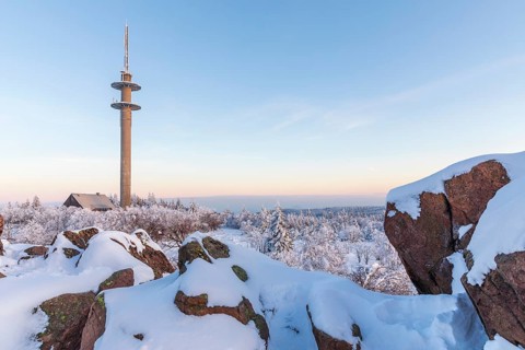 View from Großer Lugstein of the radio tower and the winter landscape with snow-covered trees and