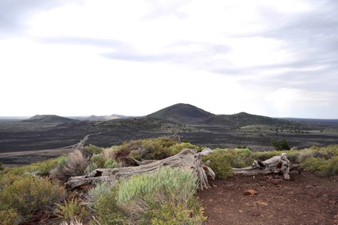 Barren lava landscape with hills under cloudy sky, Craters of the Moon National Monument, Idaho,