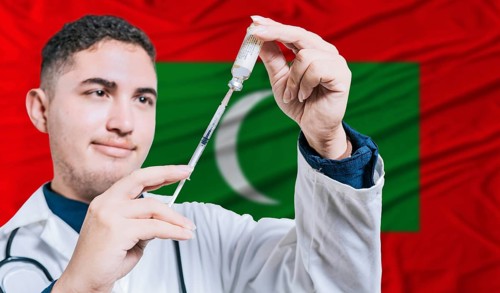 Doctor holding syringe on Maldives flag background. Medical professional holding syringe with