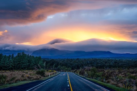 Mount Ngauruhoe in the morning at sunrise with glowing clouds, road SH 47. Tongariro National Park,