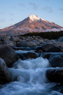 Mount Taranaki in the evening at sunset, in the foreground Stony River (Hangatahua River), Egmont