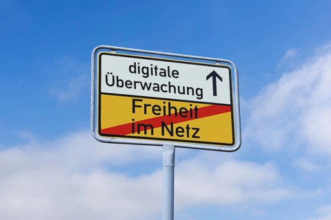 (photo montage) Exit sign with the text FREEDOM ON THE NET and DIGITAL SURVEILLANCE against a blue