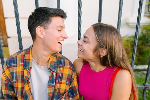 A happy lesbian couple shares a joyful moment in an urban setting, highlighting love and connection