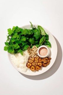 Top view of a plate with fresh ingredients for making Italian pesto gnocchi, featuring potatoes,