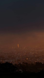 A serene sunset over San Jose, Costa Rica, captured from a mountain vantage point. The capital city