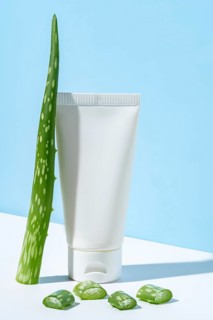 This image portrays a simple and clean representation of beauty and skincare featuring a white tube