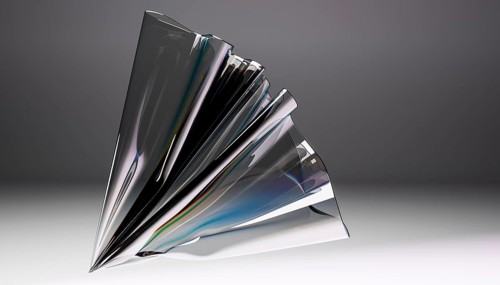 A captivating abstract sculpture crafted from glass, showcasing intricate folds and dynamic