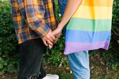 A touching close-up of a lesbian couple holding hands, symbolizing love and unity. One partner