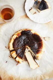 Top view of a minimalist photograph showcasing a freshly baked San Sebastian cheesecake, served on