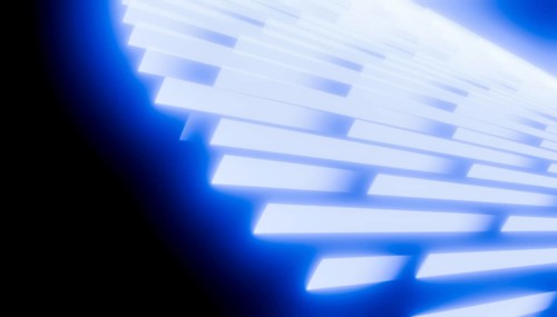 This rendering showcases a glowing blue geometric pattern with light effects. The abstract design