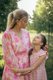 A mother and her daughter gaze at each other with love and understanding in a sunlit park Their