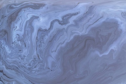A detailed close up of abstract acrylic paint gray marble with swirling patterns. This intricate