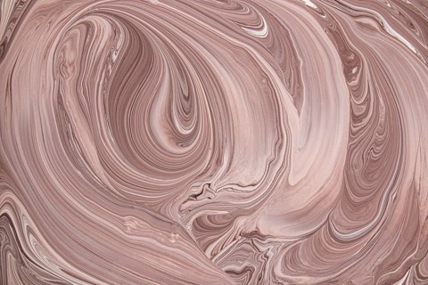 A captivating abstract image of swirling marble, showcasing smooth lines and patterns in warm